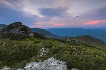 Fototapeta na wymiar Carpathian Mountains. In the setting sun paint the sky over the mountains