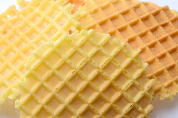 Hill round yellow crispy waffles on a white background. breakfas