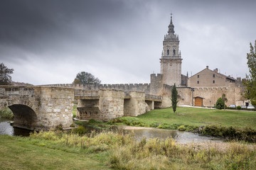 Fototapeta na wymiar ancient bridge, city wall and cathedral, Burgo de Osma on a rainy day, Soria, Spain