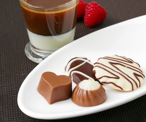 Сup of espresso wits milk and chocolate candies