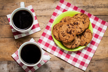 cup of coffee or tea and cookies on the rustic wooden table. Space for text.