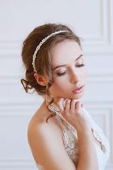 Bridal fashion. Tender woman with brown hair and pearl headpiece