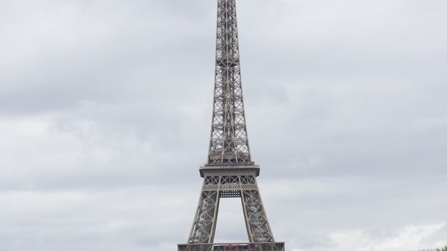 Famous Eiffel tower lattice construction in front of cloudy sky France Paris 4K 2160p 30fps UltraHD tilt footage - French monument by the day with clouds on sky 4K 3840X2160 UHD video