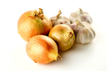 Organic unpeeled onions and garlics isolated on white