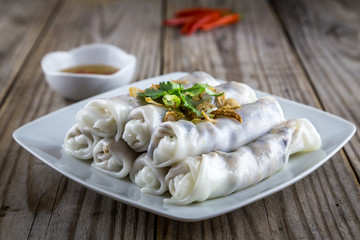 Vietnamese styled steamed rice noodle rolls with fish sauce and red pepper.