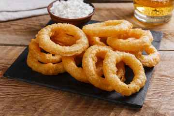 fried onion rings in batter with sauce