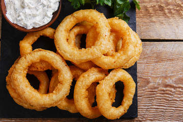 fried onion rings in batter with sauce