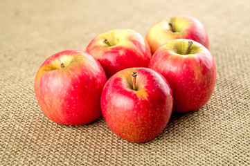 Group of bright apple fruits on burlap