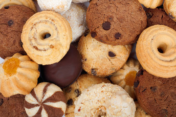 Stack of fresh cookies with chocolate and coconut flakes