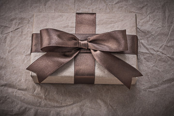 Giftbox with present tape on wrapping paper holidays concept