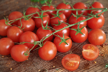 Cherry tomatoes on a wooden surface.