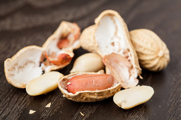 Peeled Peanut on wood background. Selective focus.