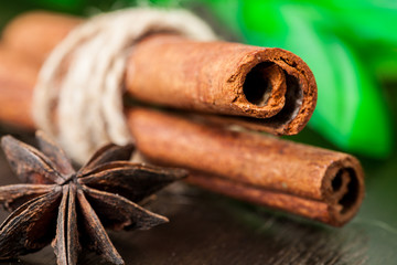 Cinnamon sticks and star anise on a wooden board. Selective focus.