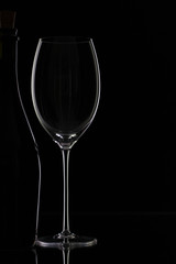 Bottle and glass on the black background