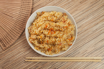 Obraz na płótnie Canvas bowl of tasty cooked rice with chopsticks
