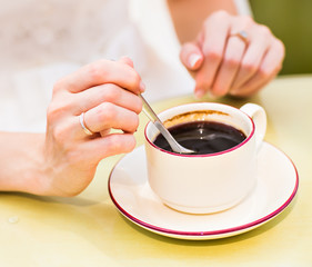 woman holding hot cup of coffee