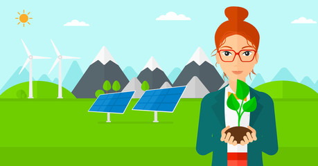 Woman holding plant.