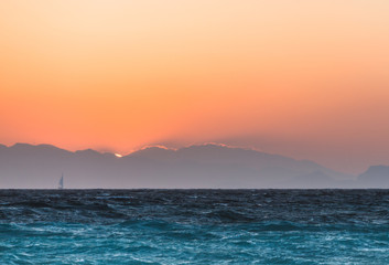 Obraz premium Yacht at sunset in the Aegean Sea. Rhodes Island. Greece