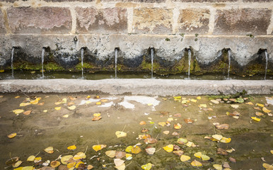 ancient water fountain with autumn leaves, Luzon, Guadalajara, Spain