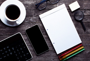Office desk supplies flat lay from above