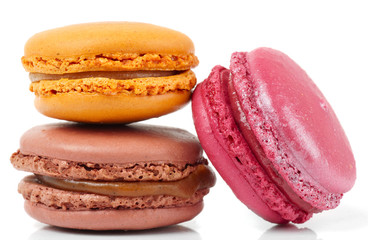 Three colorful macarons on white background