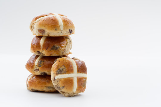 Easter hit cross buns stacked up on an isolated white background.