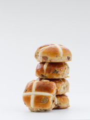 Easter hit cross buns stacked up on an isolated white background.