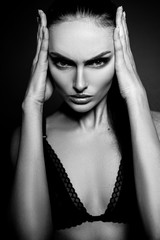 Fototapeta na wymiar Elegant beautiful girl model with hair gathered in a ponytail. Black and white art photo.