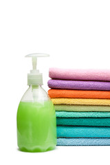 colorful towels and liquid soap isolated over white background