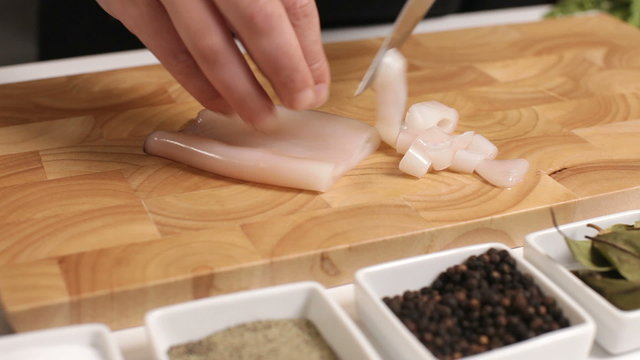 Cutting squid on a cutting board