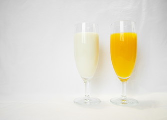 milk and orange in wineglass