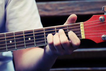 Hands playing acoustic guitar