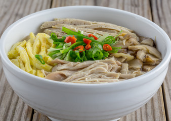 Vietnamese vermicelli with egg, pork, chicken and shiitake mushroom in a hot broth.