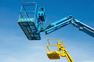 Two crane's baskets against clear sky