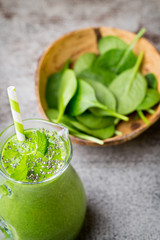 Spinach smoothie, on the grey  background.
