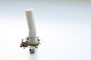 Cigarette butt closeup on gray background