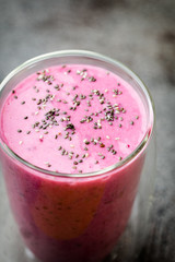 Smoothie, pink juice on the grey  background.