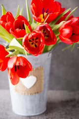 Red tulips on a wooden background.