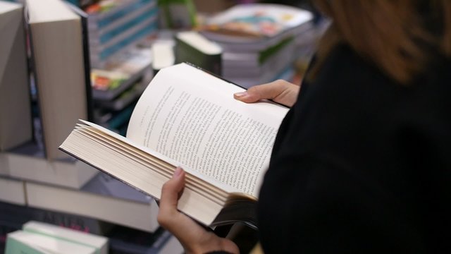 Woman browsing book,  slowmotion footage