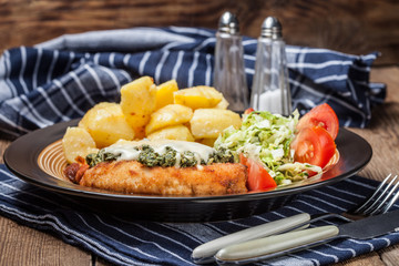 Fried chicken fillet with spinach and cheese.