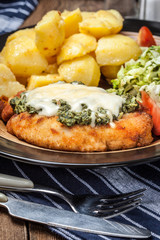 Fried chicken fillet with spinach and cheese.