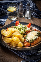 Fried chicken breast with spinach and cheese.