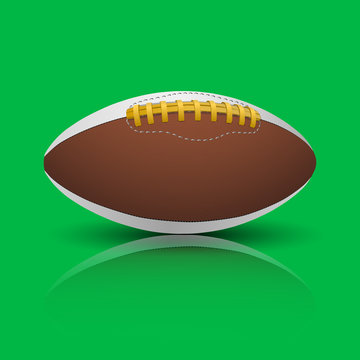 Rugby, american football ball isolated on green background.