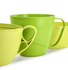 three plastic mugs yellow and green