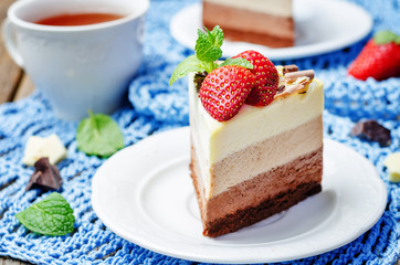three chocolate cake decorated with strawberries and mint leaves
