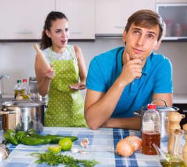 Couple quarreling at kitchen