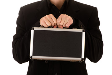 man strong keeps in a black jacket and a black shirt before himself a metal case