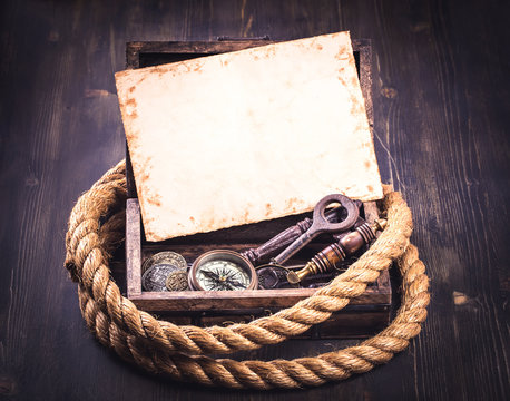 Old card and marine accessories in wooden box