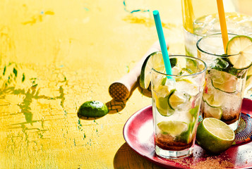 Tray of caipirinha drinks over yellow background