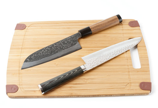 Two expensive japanese knives on cutting board
